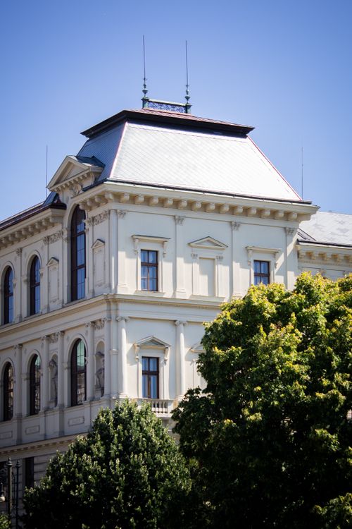 Free A classic European-style building with ornate architecture set against a clear blue sky. Stock Photo