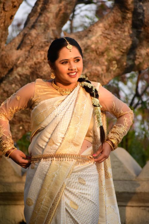 Free A smiling woman wearing a traditional Indian sari outdoors, showcasing cultural elegance. Stock Photo