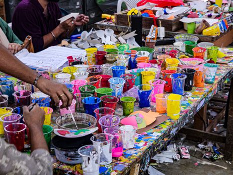 A colorful display of paint and art supplies in a creative workshop.