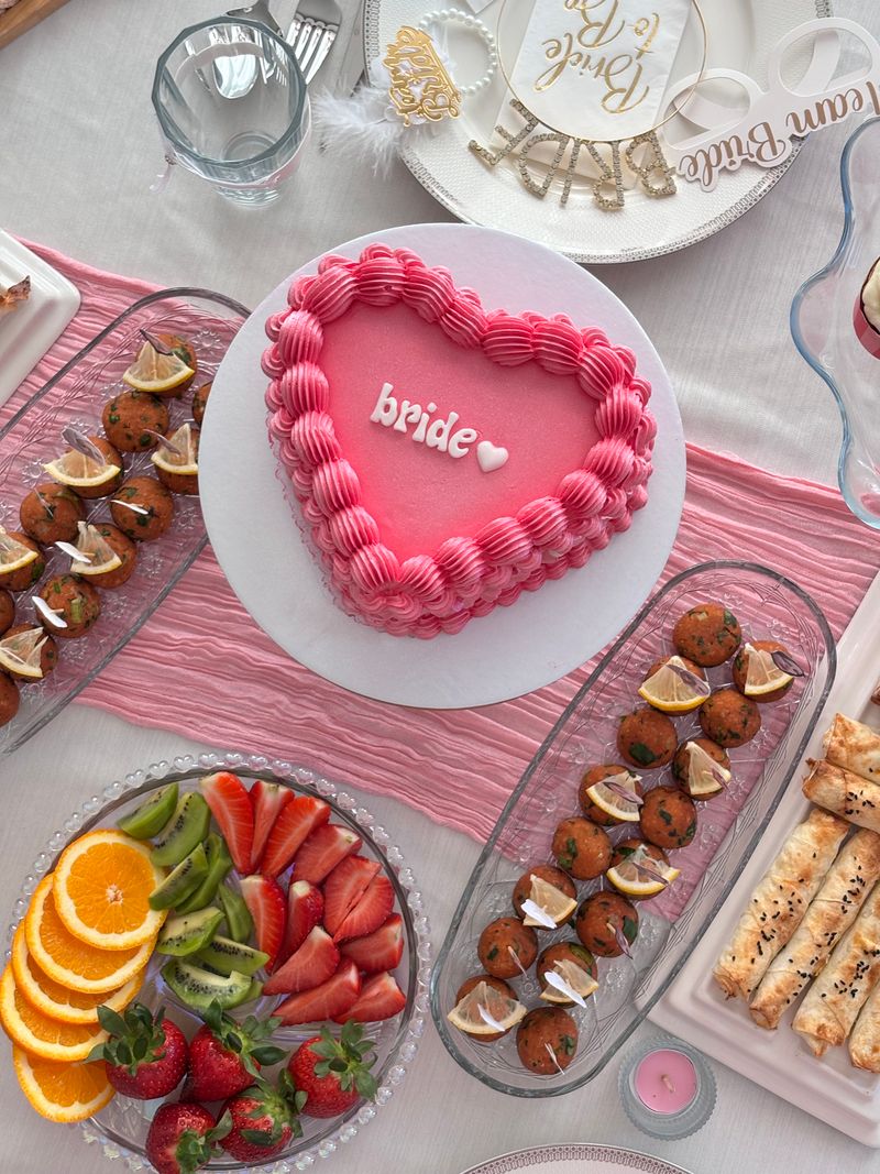 Romantic bridal shower dessert table with cake and floral styling