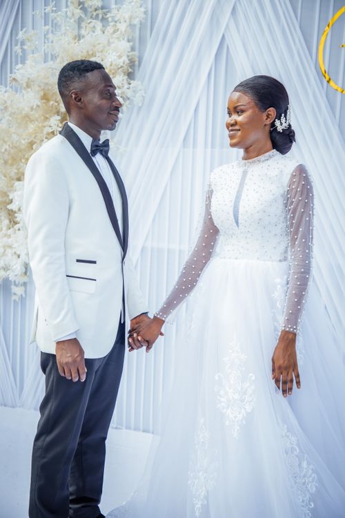 Free Bride and groom in stylish attire at an elegant wedding ceremony. Stock Photo