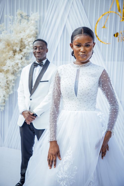 Free Sophisticated wedding photo capturing the bride in a white gown and groom in a tuxedo. Stock Photo