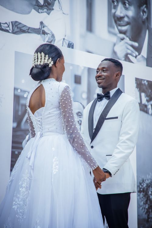 Free A joyful couple shares a moment in elegant wedding attire, highlighting love and sophistication. Stock Photo