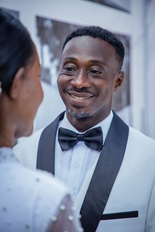 Free Elegant close-up of a couple in wedding attire sharing a joyful moment. Stock Photo