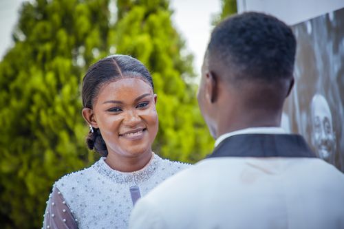 Free A smiling bride and groom share a joyful moment in an outdoor wedding setting. Stock Photo