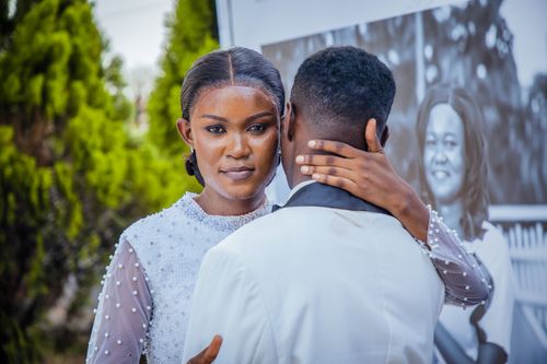Free A couple embracing during a wedding ceremony outdoors, showcasing elegance and affection. Stock Photo