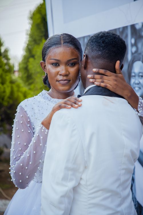 Free Beautiful couple sharing an intimate embrace on their wedding day. Stock Photo