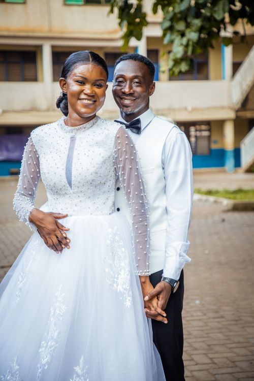 Free Beautiful outdoor wedding portrait of an African couple in elegant attire, radiating joy and love. Stock Photo