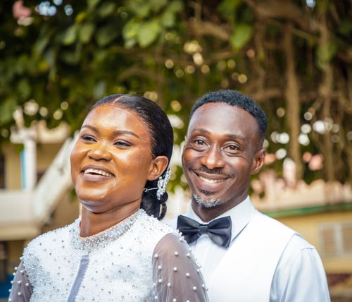 Free Happy bride and groom smiling joyfully during their wedding outdoors. Stock Photo