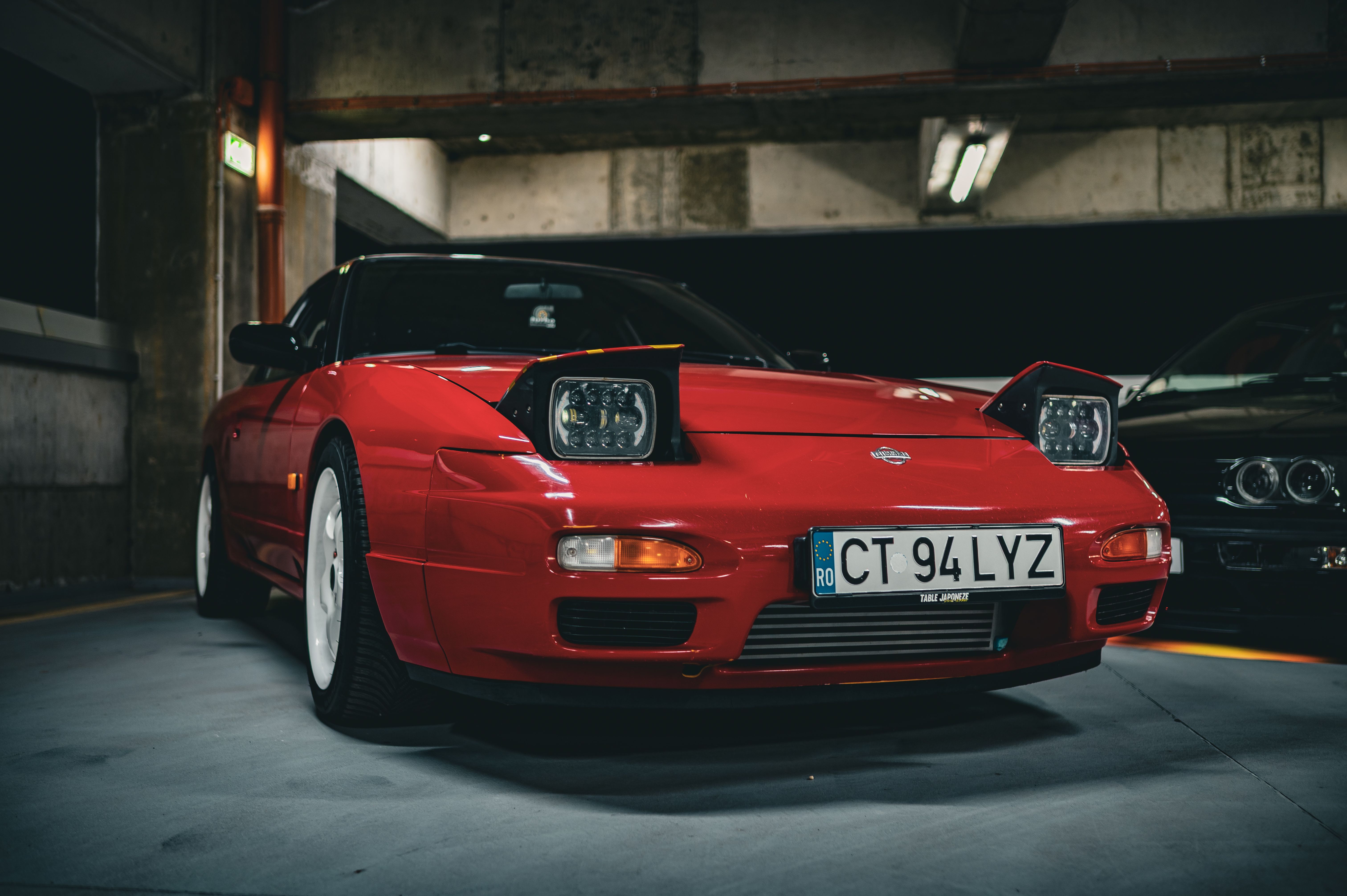 Vintage Red Sports Car in Dim Garage Lighting · Free Stock Photo
