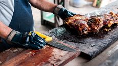 Authentic Argentine barbecue being prepared by a cook in Uribelarrea, Buenos Aires.