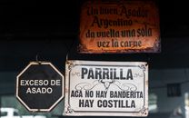 Vintage signs at an Argentinian grill highlighting asado culture in Uribelarrea.