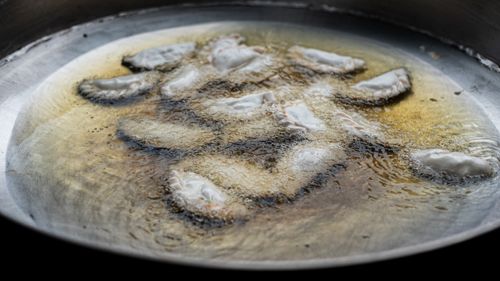 Free Fresh empanadas frying in oil in Uribelarrea, Buenos Aires, showcasing Argentine cuisine. Stock Photo