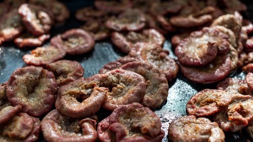 Free Close-up of grilled chinchulines on a parrilla in Uribelarrea, Argentina. Stock Photo