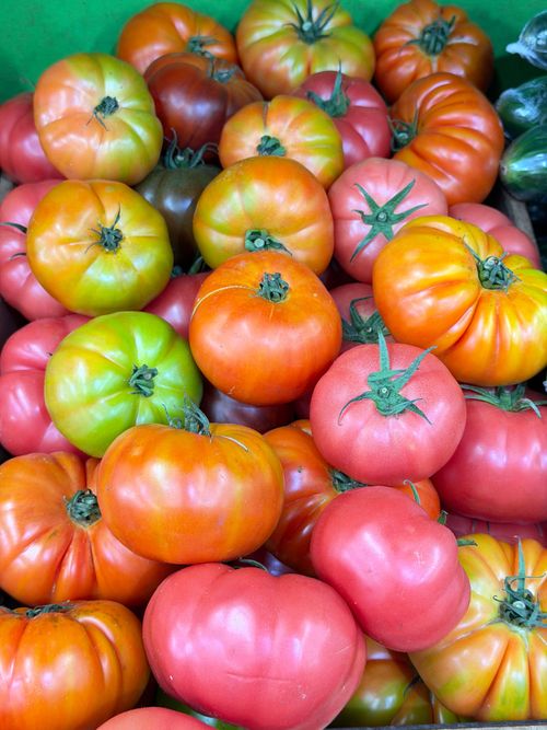 Free A colorful assortment of fresh heirloom tomatoes at a farmers market. Stock Photo