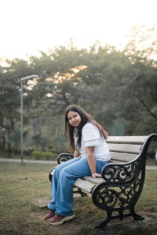 Young Woman Sitting on a Park Bench in Spring · Free Stock Photo