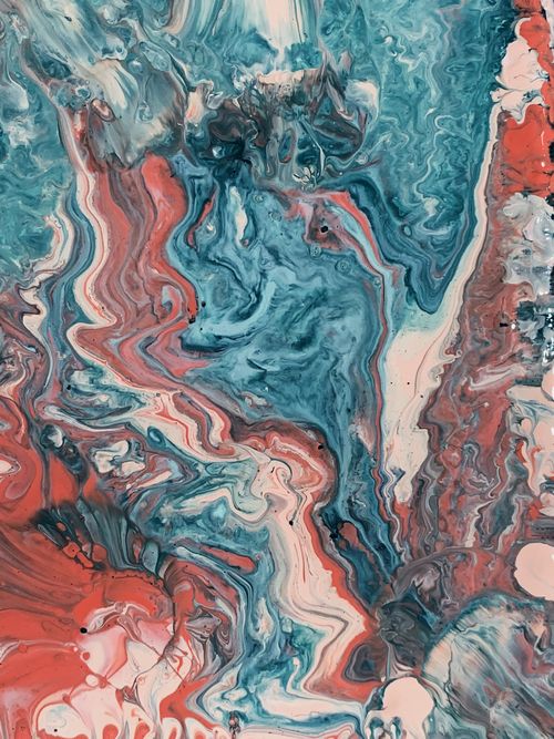 Free A close-up of vibrant abstract fluid art showcasing swirling blue and red colors. Stock Photo