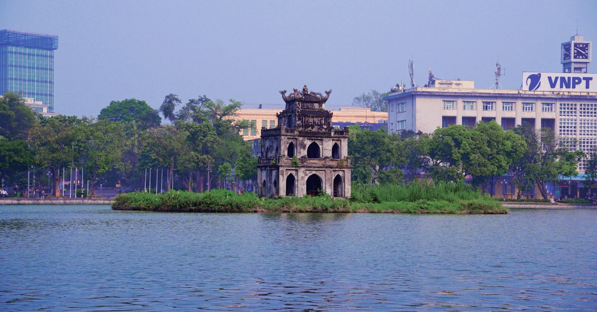 Hoan Kiem Lake in Hanoi with Thap Rua tower and surrounding trees