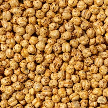 A detailed close-up of crispy roasted chickpeas, highlighting their texture and color.