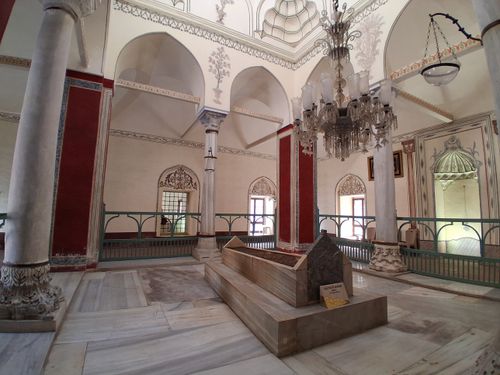 Free Explore the intricate architecture and decor of a historical mausoleum interior with arched ceilings and chandeliers. Stock Photo