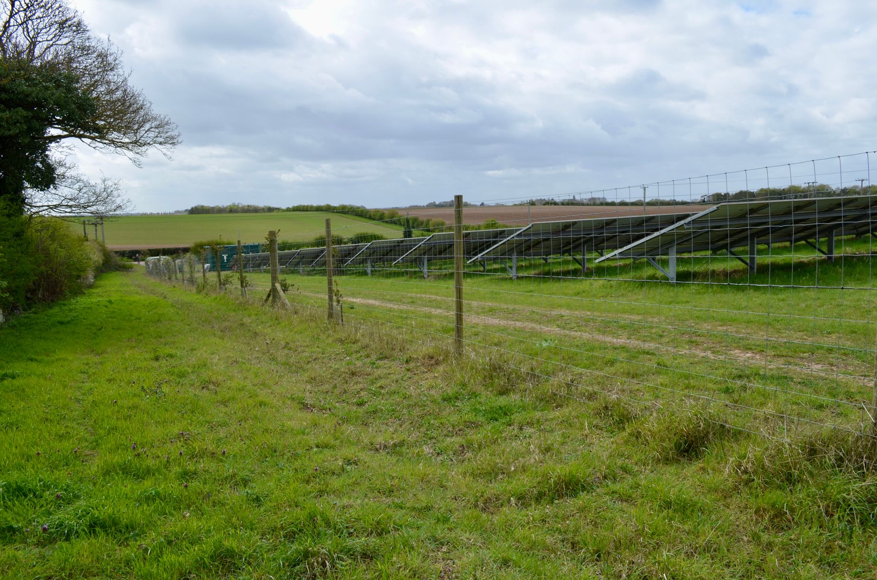 Utility-scale solar array penned behind tall security fencing