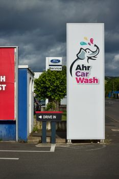 Colorful Ahr Car Wash sign with elephant logo under a dramatic sky. 37062262