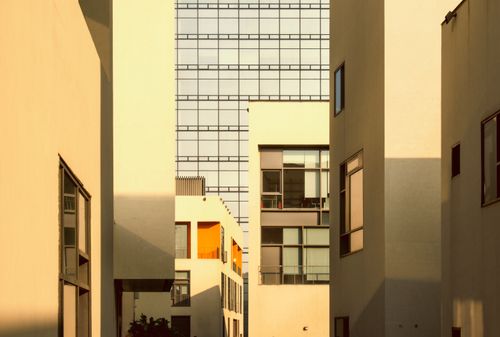 Free Modern buildings with warm sunset lighting highlighting minimalist design in an urban setting. Stock Photo