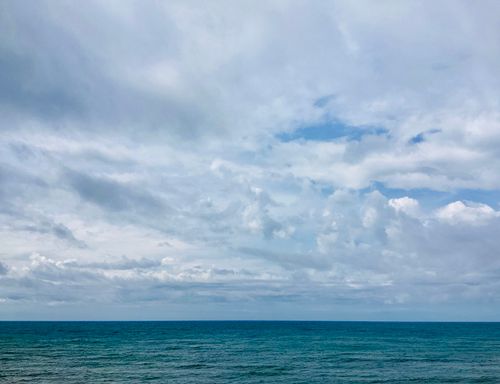 Free Tranquil ocean scene with expansive sky and clouds, perfect for relaxation themes. Stock Photo