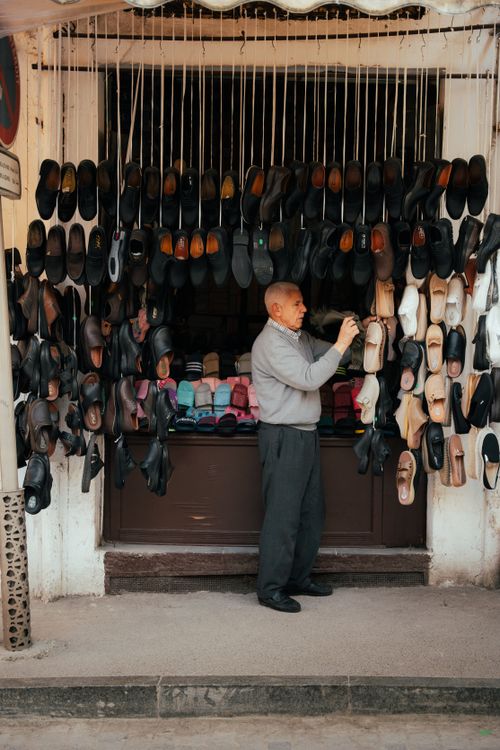 Free An elderly man organizing shoes at his street stall in Tangier, Morocco. Stock Photo