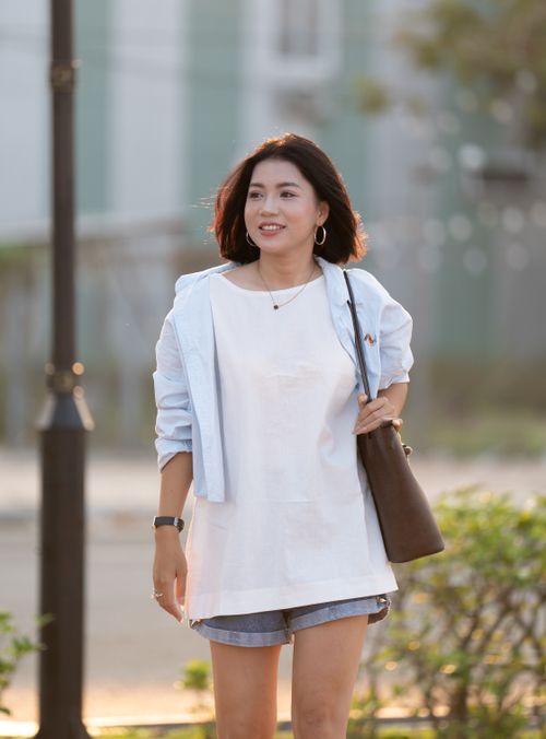 Free Happy woman wearing casual clothes walking outside with a smile. Stock Photo