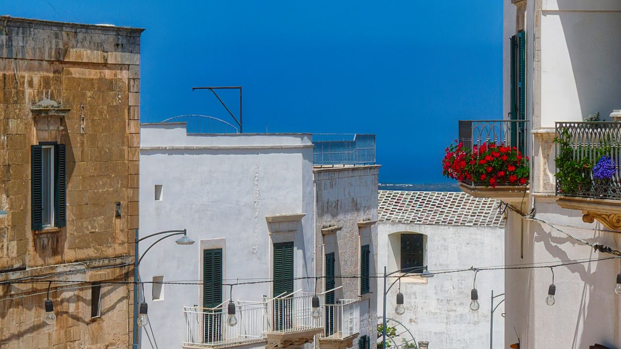 explore the picturesque whitewashed buildings and vibrant balconies of