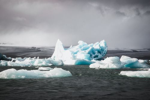 Free Dramatic view of icebergs in Iceland's glacial lagoon under a stormy sky. Stock Photo