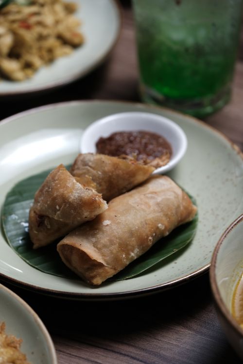 Free Crispy spring rolls served on a plate with dipping sauce, perfect for appetizers. Stock Photo