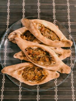 Traditional Turkish pide served on a glass plate, showcasing authentic flavors.