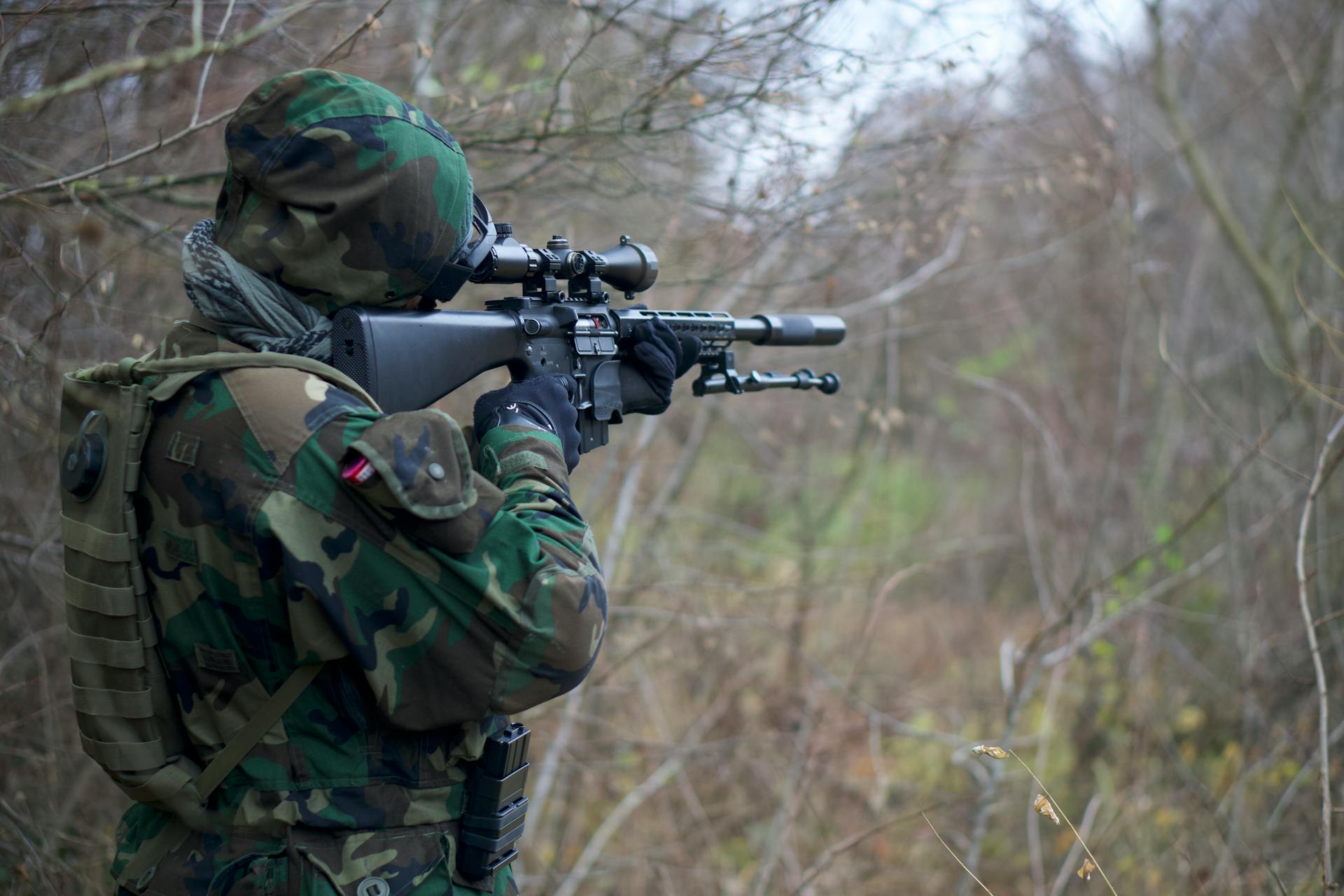 Man in  Camouflage Army Uniform Holding Rifle