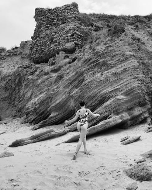 Woman in Bikini Walking on Sand