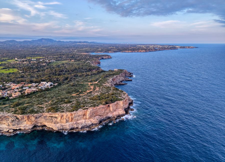 A breathtaking aerial view of the rugged coastline and azure waters of Mallorca, Spain.