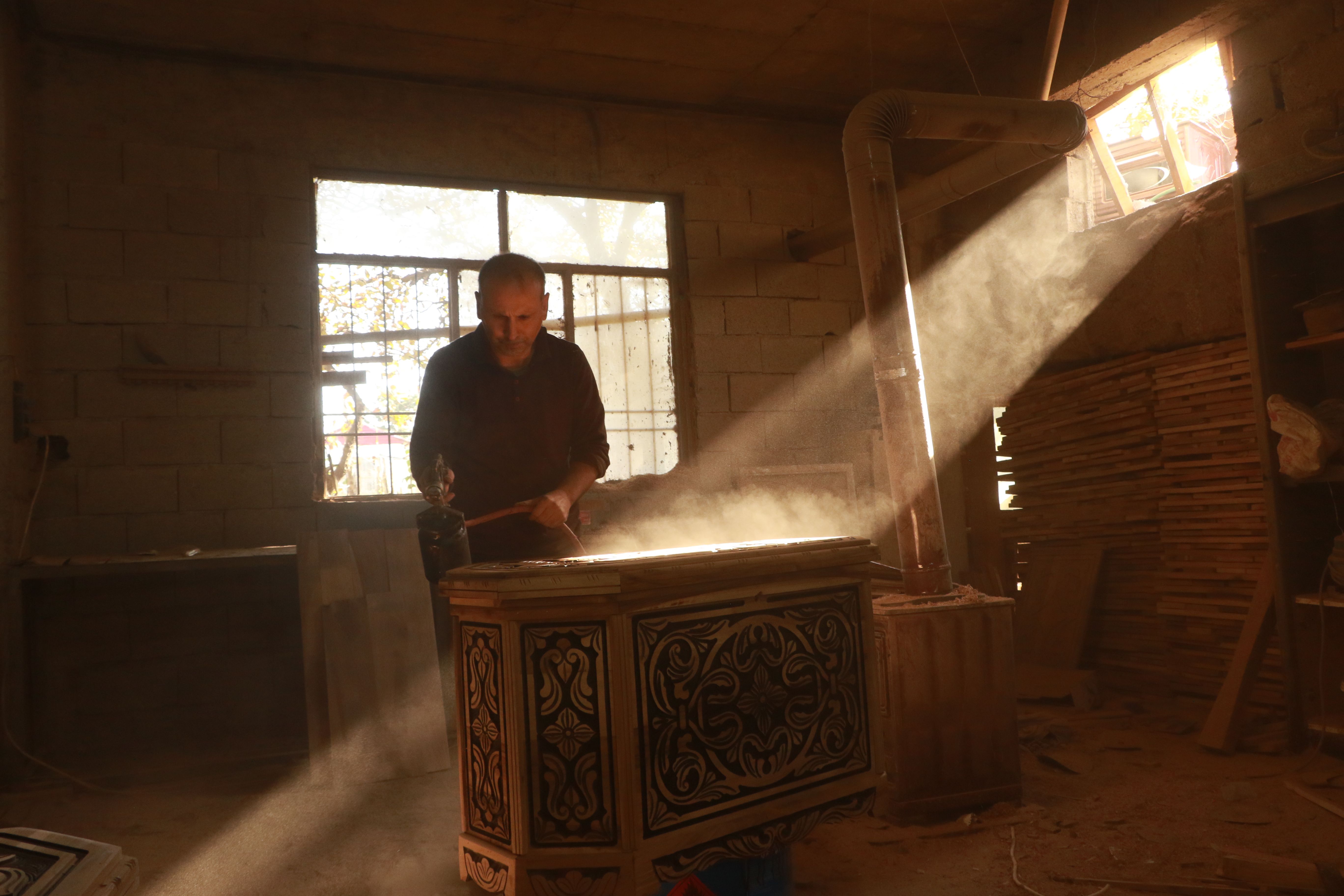 Craftsman carefully working on wooden furniture