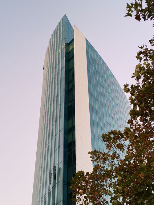 Free A modern glass skyscraper in Santiago, Chile with autumn leaves. Stock Photo