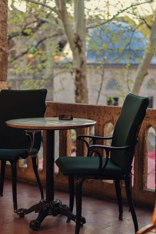 Free Cozy outdoor café scene with empty seating on a terrace during spring. Stock Photo