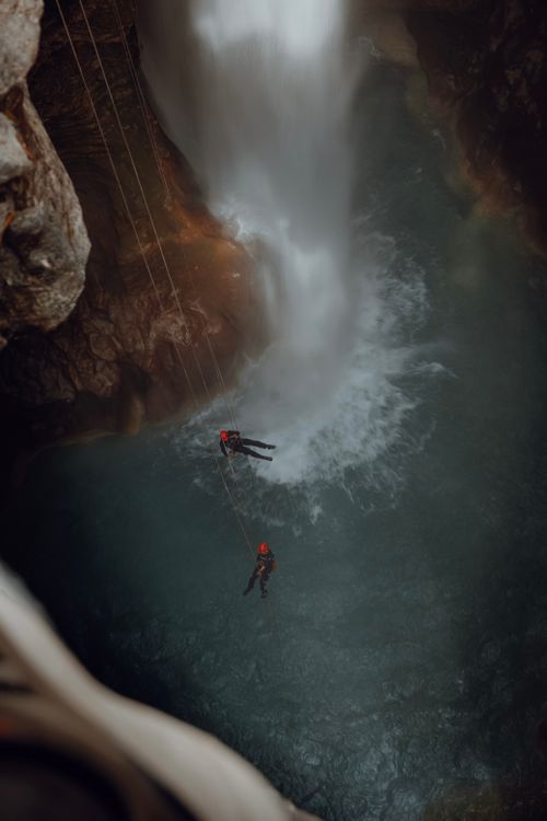 Free Two people canyoning down a waterfall in Antalya, Türkiye, showcasing adventure and excitement. Stock Photo