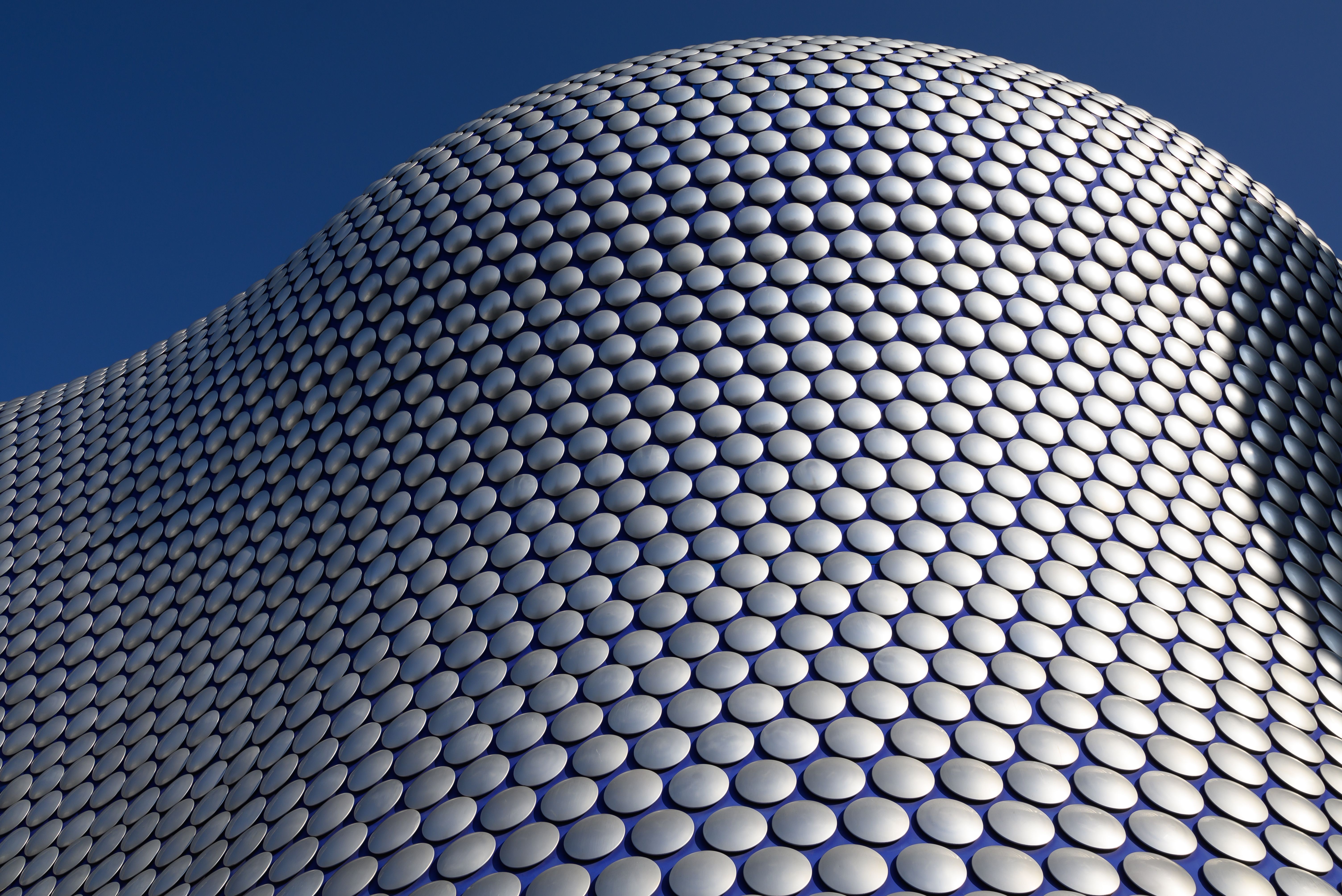 Modern abstract view of Bullring's circular facade. Iconic Birmingham architecture.
