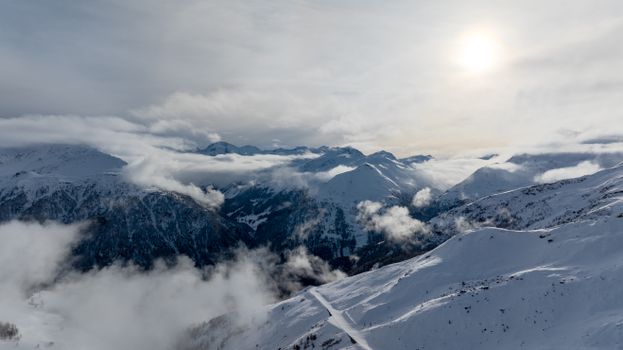 Stunning aerial shot of the snow-covered Korutany mountains under a bright sky.