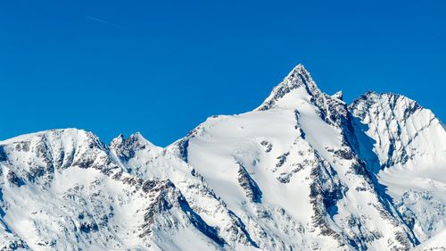 Free Stunning view of snow-covered mountains in Korutany, Austria, under a clear blue sky. Stock Photo
