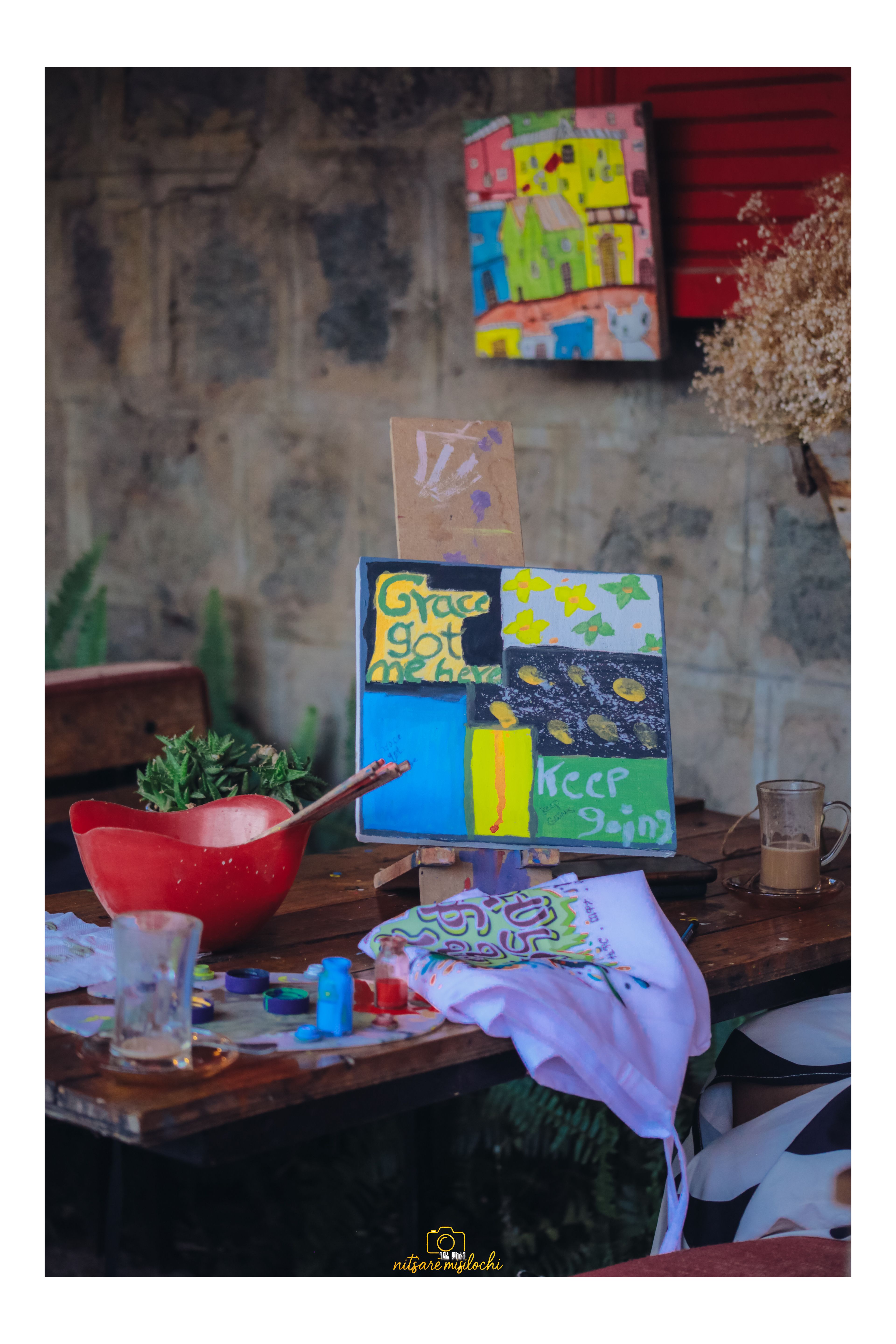 Colorful abstract artwork on canvas with paint supplies in Addis Ababa, Ethiopia.