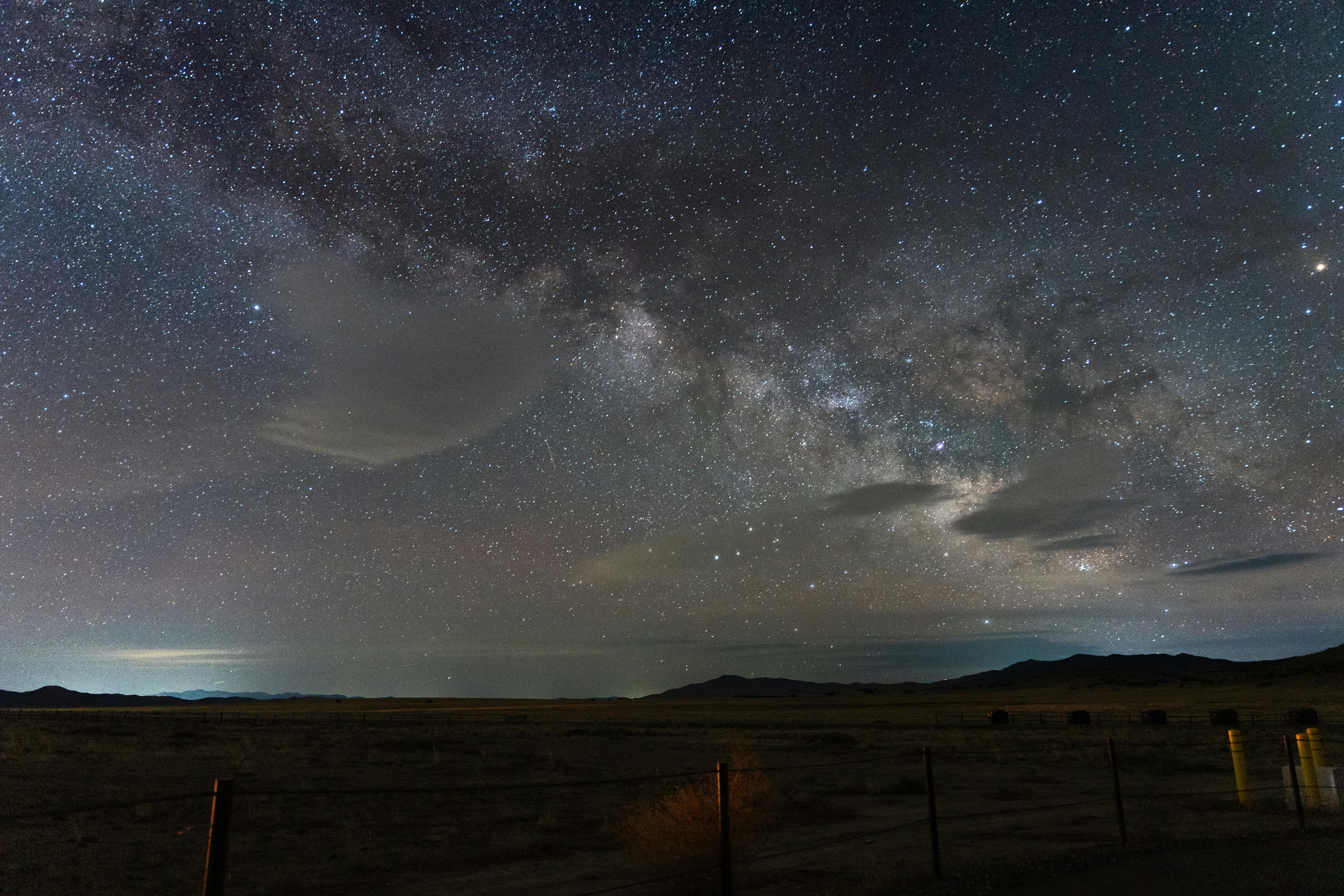 Capture of the Milky Way shining bright in the dark skies over the Utah desert landscape.