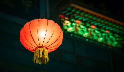 Free Vibrant red lantern glowing at night, symbolizing cultural festivities. Stock Photo