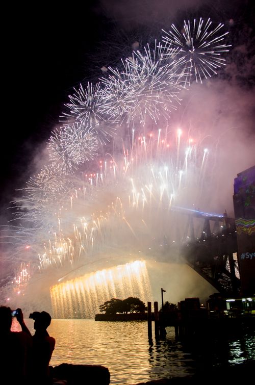 Free Vibrant fireworks illuminate the night sky over Sydney Harbour Bridge. Stock Photo
