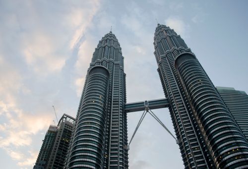 Free Iconic view of the Petronas Towers against a dusk sky in Kuala Lumpur, Malaysia. Stock Photo