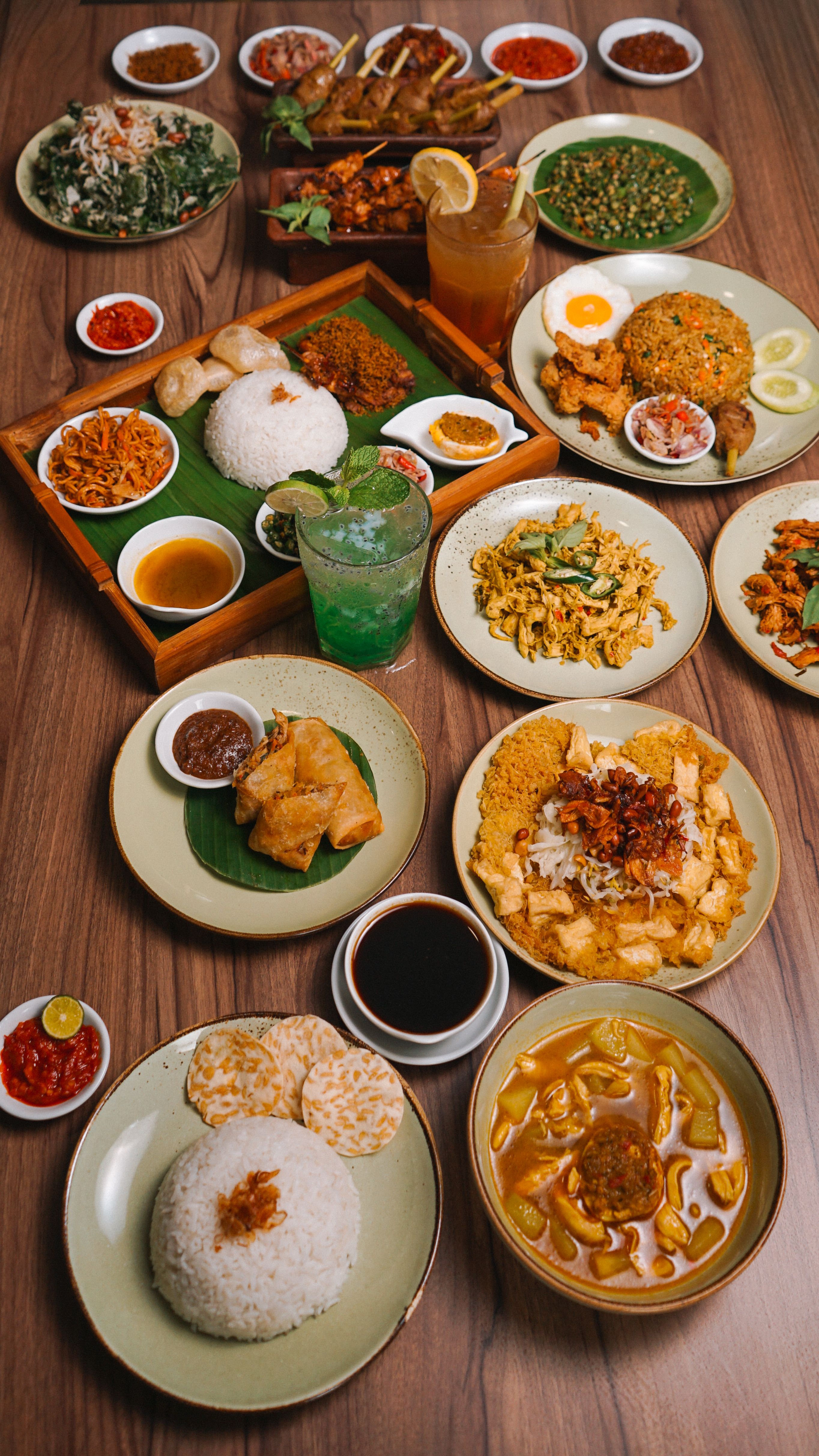 A vibrant display of classic Indonesian cuisine with rice and side dishes.